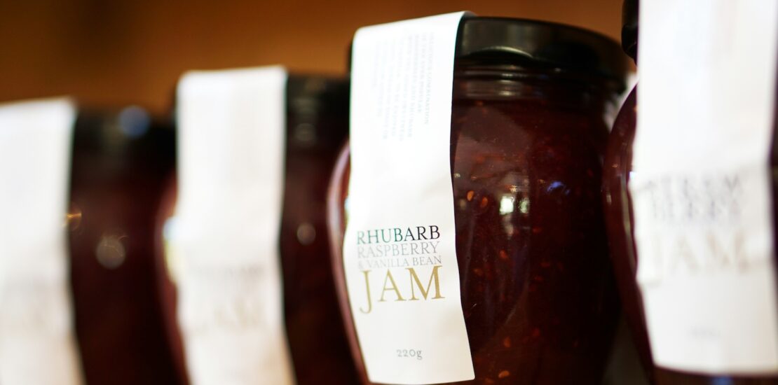 A row of jars filled with jam.