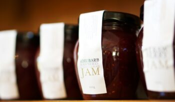 A row of jars filled with jam.