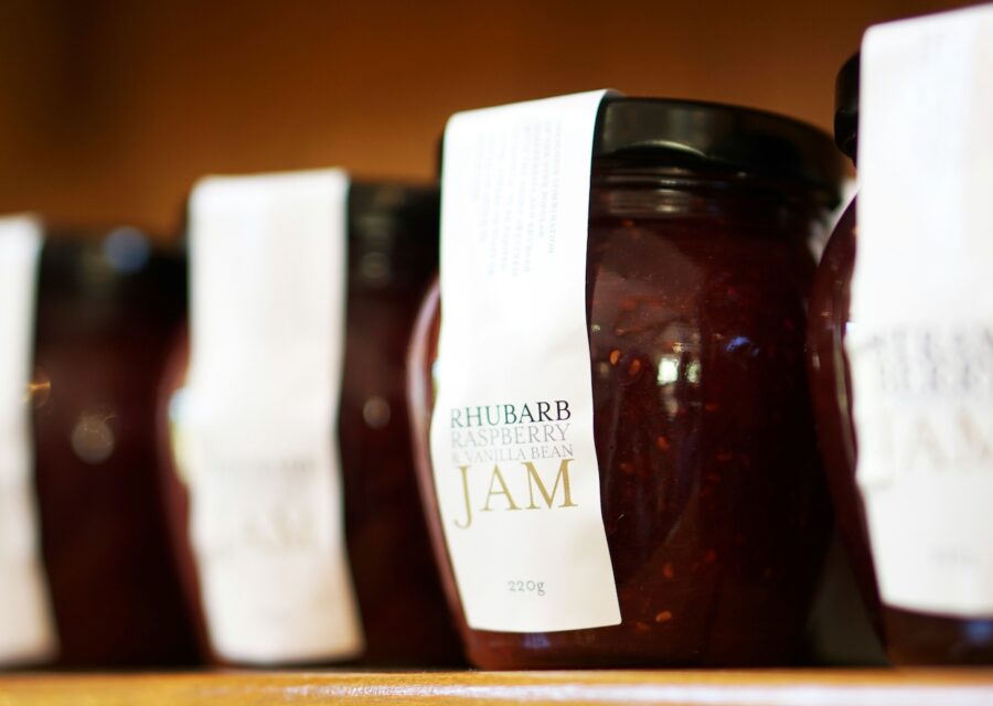 A row of jars filled with jam.